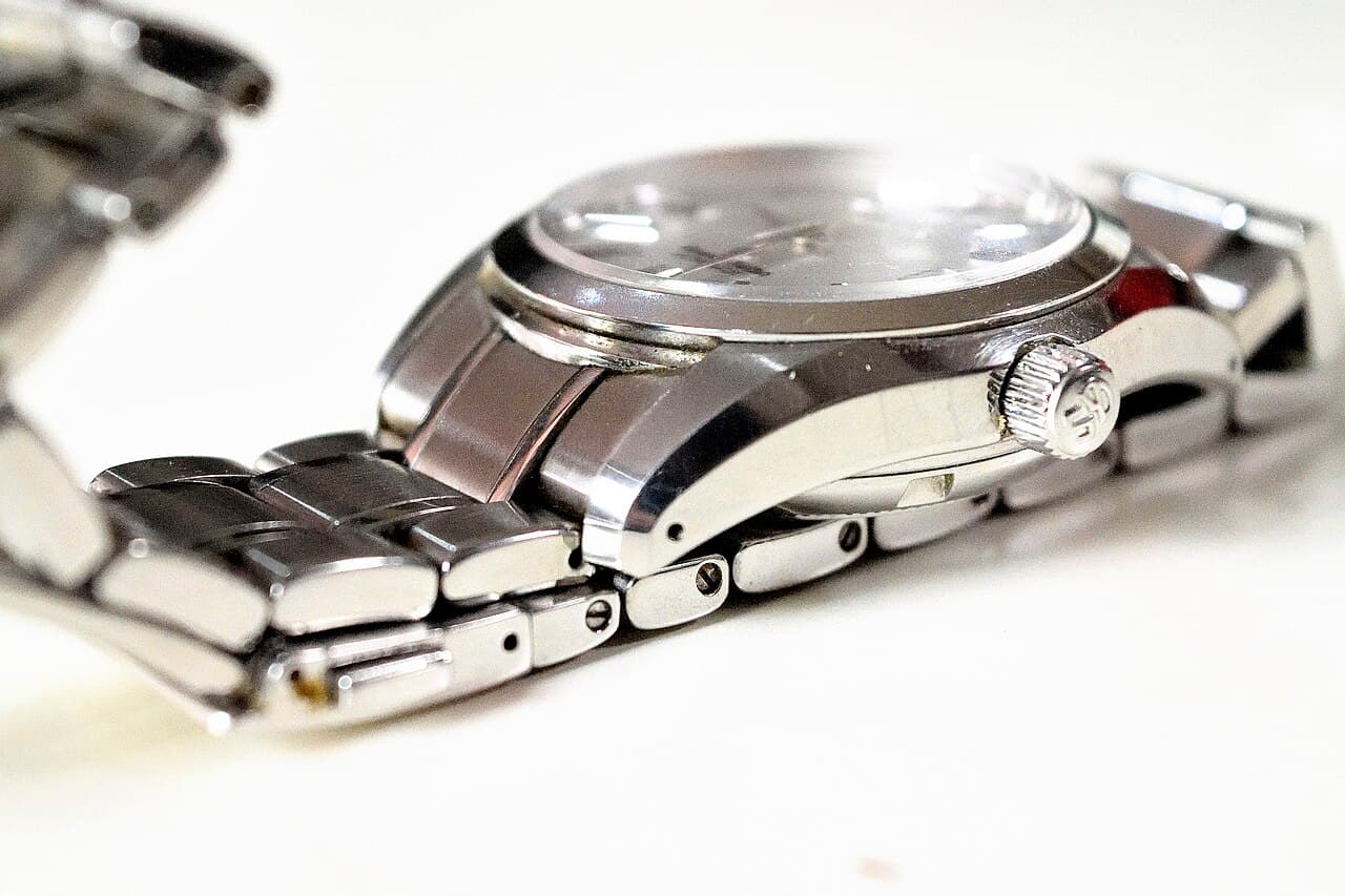 A Grand Seiko wristwatch (SBGR051) side view — illustrative of Grand Seiko's case finishing, not the specific SBGA211 Snowflake model discussed in this article